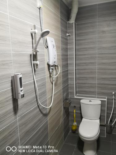 a bathroom with a shower and a toilet in a room at TB HOMESTAY Tasek klebang(taman bertuah) 10pax wifi in Chemor