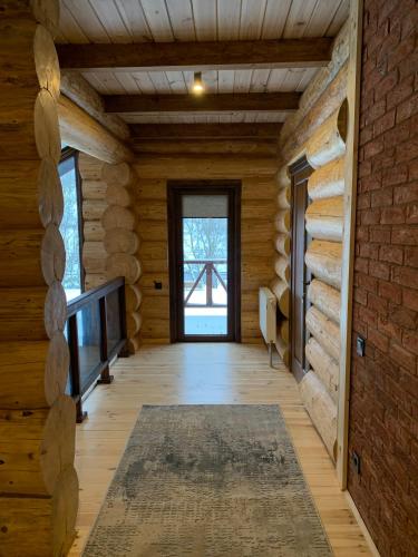 a hallway in a log cabin with a television and a window at 4REST ZRUB in Tukhlya