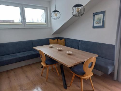 a dining room with a wooden table and chairs at Pension Baldauf - Dorf 31 in Kleinarl