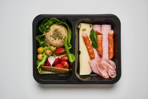 a black container filled with different types of food at AGA Tenis Apartments by Radwańska in Krakow