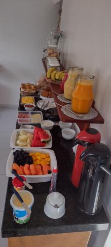 a table with several trays of food on it at Jangadas do Pontal in Fortim