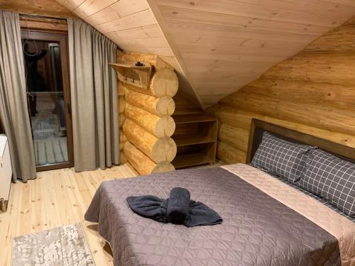 a bedroom with a bed with a hat on it at 4REST ZRUB in Tukhlya