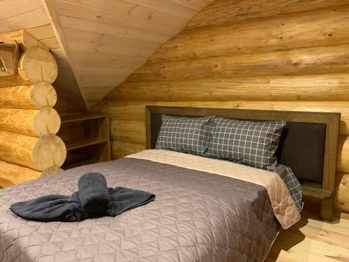a bedroom with a bed with a hat on it at 4REST ZRUB in Tukhlya