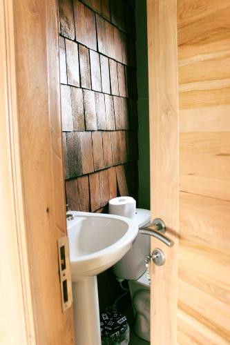 a bathroom with a sink and a toilet at Cabañas Arrayanes de Huillinco en Chiloé in Chonchi