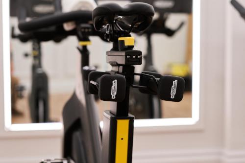a camera on a tripod in front of a mirror at The Mayfair Townhouse - an Iconic Luxury Hotel in London
