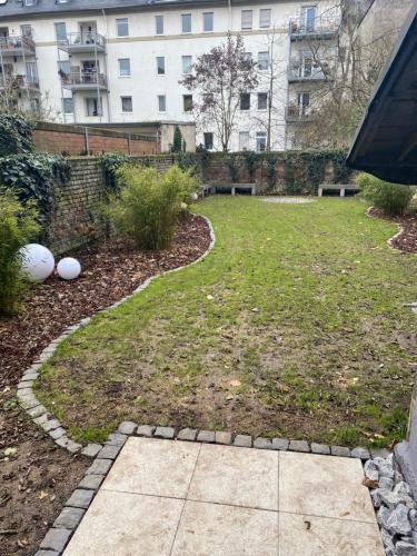 a backyard with a lawn and a walkway at H-85 SUITES Level 5/9 in Koblenz