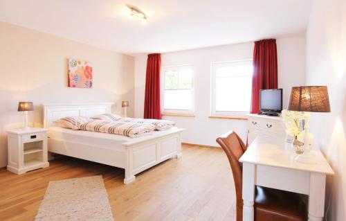 a bedroom with a bed and a table and a desk at Gästehaus Münks in Meerbusch