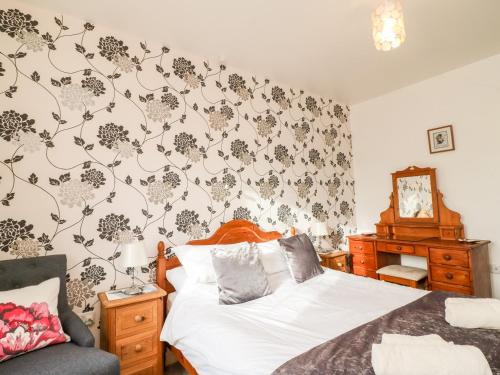 Katil atau katil-katil dalam bilik di Littleham Court Cottage