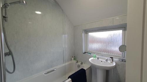 a bathroom with a sink and a bath tub and a sink at 51 Milton Crescent in Anstruther