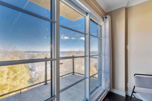 Habitación con ventana grande con vistas. en INITIAL - ROAD TRIP - Chutes-Montmorency - VUE FLEUVE, en Boischâtel