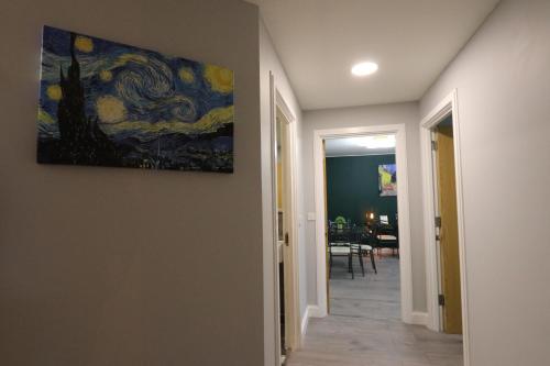 a painting hanging on a wall in a hallway at Stunning Top Floor Southside Apartment 2 BEDS PARKING WIFI NETFLIX in Birmingham