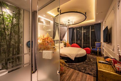 a hotel room with a bed and a bathroom at Mai Hotel in Hanoi