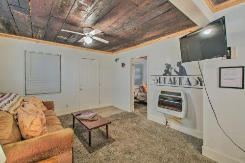a living room with a couch and a flat screen tv at Hot Springs Home 2 Mi to Hot Springs Natl Park in Hot Springs
