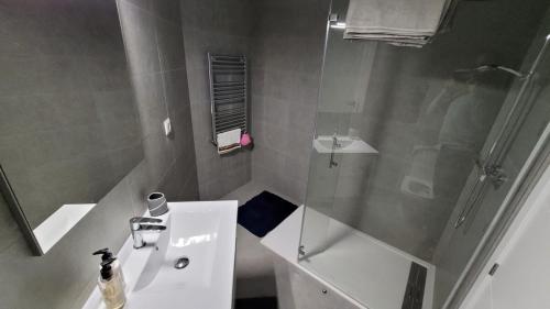 a white bathroom with a shower and a sink at VILLA PALMITO Mar Menor Golf in Torre-Pacheco