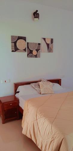 a bedroom with a bed and a night stand next to it at Katihalli Estate Stays in Hassan