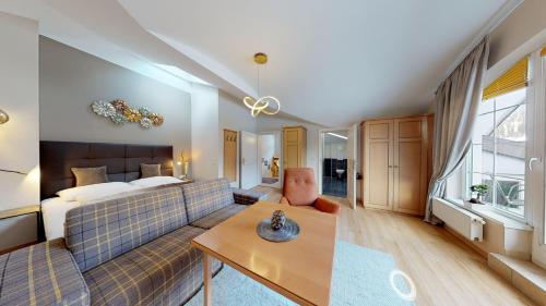 a living room with a couch and a bed at Appartementhaus Tristenau in Pertisau