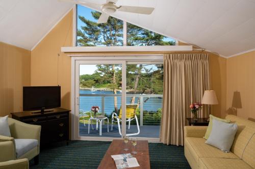 a living room with a couch and a view of the water at Dockside Guest Quarters in York