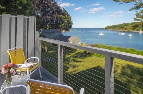a balcony with two chairs and a view of the water at Dockside Guest Quarters in York