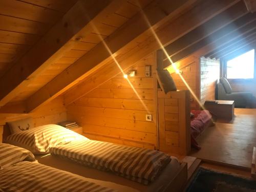 a room with two beds in a attic at CaLegna Ferienchalet in Bad Kohlgrub