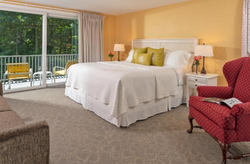 a bedroom with a large bed and a balcony at Dockside Guest Quarters in York