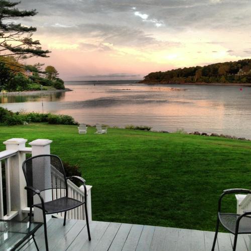 a porch with chairs and a view of the water at Dockside Guest Quarters in York