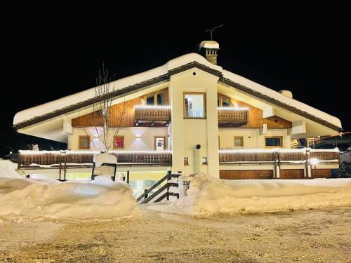 a building with snow on the ground in front of it at Shatush Hotel in Courmayeur