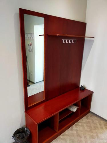 a wooden dresser with a mirror in a room at SULO Bautino Hotel in Bautino