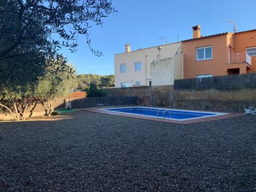 a swimming pool in front of a house at Duplex Costa Brava in Palafrugell