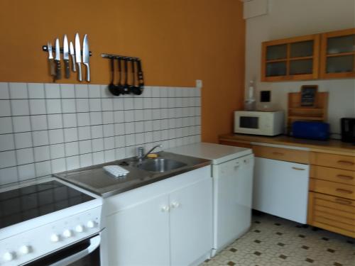 a kitchen with a sink and a counter top at Gîtes Les Clairets - Normandie in Mortain