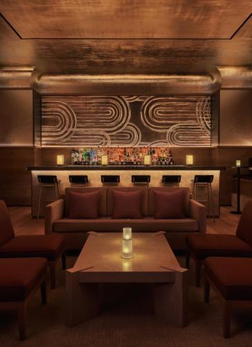 a living room with a couch and a table at Pendry Manhattan West in New York