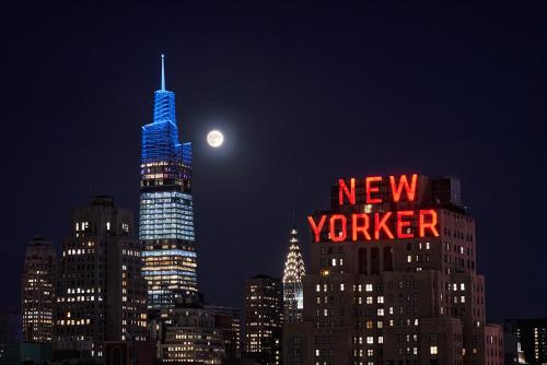 a new york city skyline at night with the moon at Pendry Manhattan West in New York