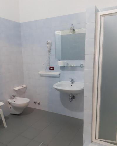 a white bathroom with a sink and a toilet at Da Santo Hotel Ristorante Pizzeria in Ferrara