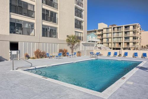a swimming pool in front of a building at The Gulf Tower Condos in Gulf Shores