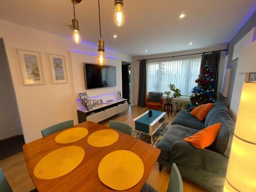 a living room with a table and a christmas tree at Blarmore Apartment Inverness in Inverness