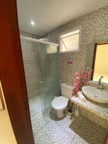 a bathroom with a shower and a toilet and a sink at Boas Vistas Canoa Quebrada in Aracati
