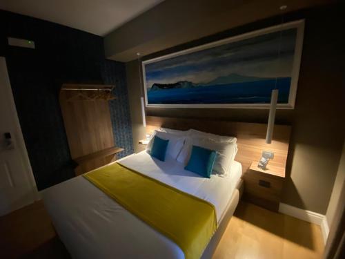 a bedroom with a large bed with a yellow blanket at 7th Floor Suite in Naples