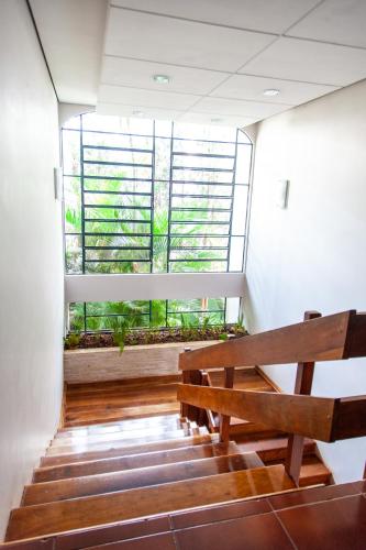 a bench in a room with a large window at Vila Verde Hotel in Toledo