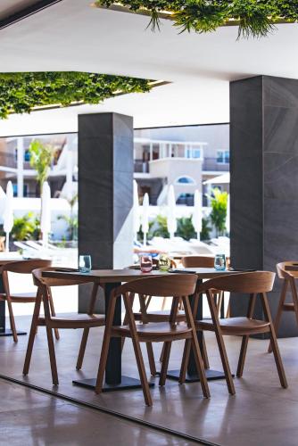 a group of tables and chairs on a patio at MYND Adeje in Adeje
