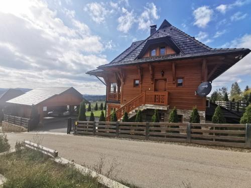 a large wooden house with a roof at Vila Engelshof - Zlatibor in Zlatibor