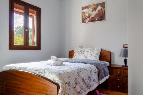 a bedroom with a bed and a window at Vila Palma in Berat
