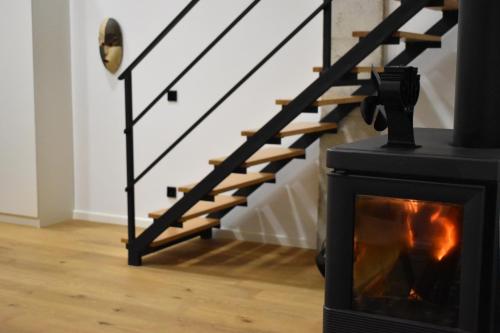 a fireplace in a living room next to a staircase at Casa Encina in Murcia