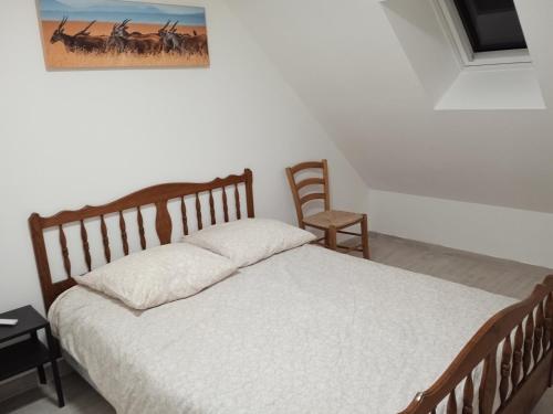 1 dormitorio con 1 cama y una foto en la pared en Maison Plélauff, en Plélauff