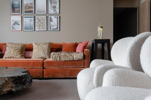 a living room with a couch and two chairs at ILY Hotels & Spa La Rosiere in La Rosière