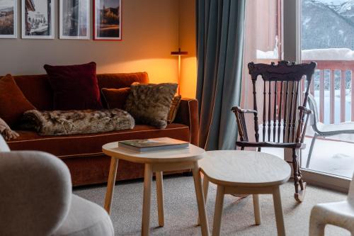 a living room with a couch and a chair at ILY Hotels & Spa La Rosiere in La Rosière