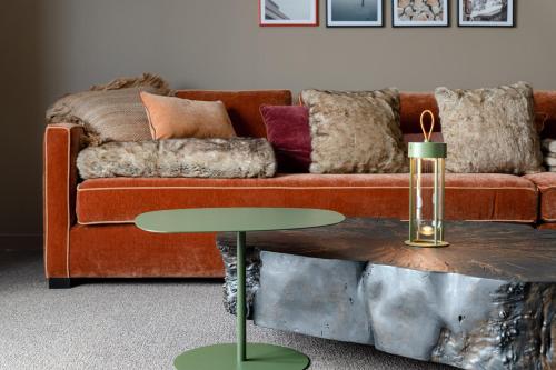 a living room with a couch and a table at ILY Hotels & Spa La Rosiere in La Rosière