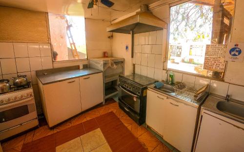 a small kitchen with a stove and a sink at La Casa del Sol Naciente in San Pedro de Atacama