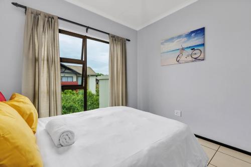 a bedroom with a white bed and a window at Smartz Apartment 76 in Midrand