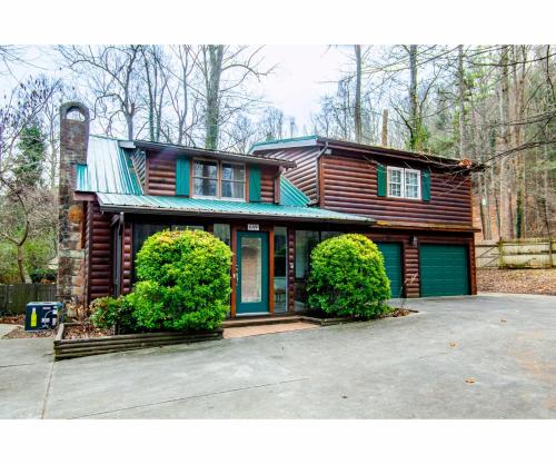 a wooden house with a driveway in front of it at City Hideaway - Hot Tub, Fireplace, Grill in Gatlinburg