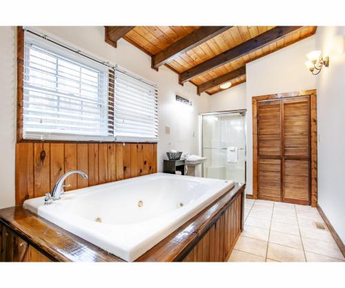 a large white bath tub in a bathroom at City Hideaway - Hot Tub, Fireplace, Grill in Gatlinburg