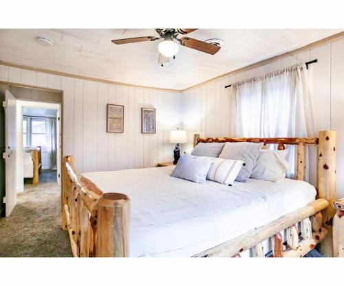 a bedroom with a large bed with a wooden headboard at City Hideaway - Hot Tub, Fireplace, Grill in Gatlinburg